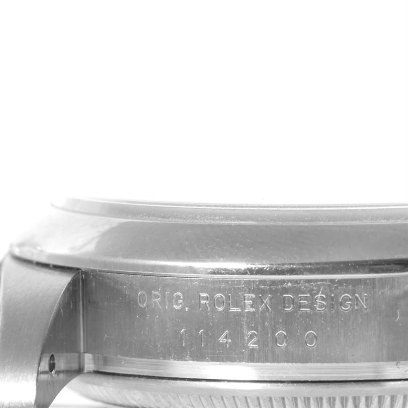 The image shows a close-up of the side of a Rolex Air-King 114200 Men's Stainless Steel Blue Dial 114200 Men's Stainless Steel Blue Dial watch, displaying the model number and "Orig. Rolex Design" engraving.