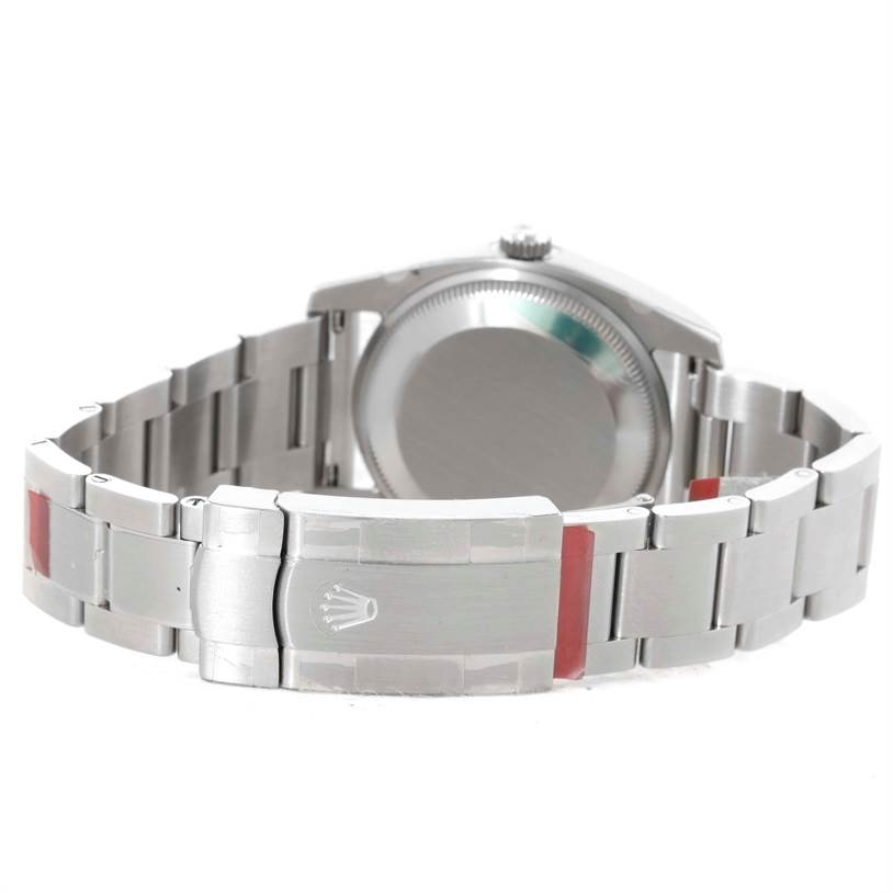 The image shows the backside of a Rolex Air-King 114200 Men's Stainless Steel White Dial 114200 Men's Stainless Steel White Dial watch, focusing on the bracelet and the clasp with the Rolex logo.