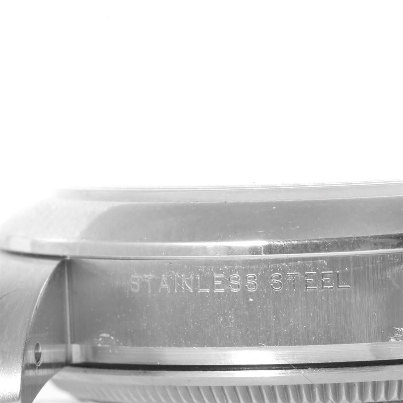 The image shows a close-up, side view of the stainless steel casing of a Rolex Air-King 114200 Men's Stainless Steel White Dial 114200 Men's Stainless Steel White Dial watch.