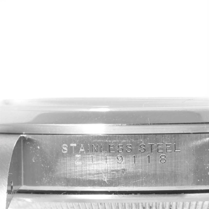 This image shows the side view of the casing of a Rolex Air-King 14000 Men's Stainless Steel Blue Dial 14000 Men's Stainless Steel Blue Dial, displaying the "STAINLESS STEEL" engraving and serial number.