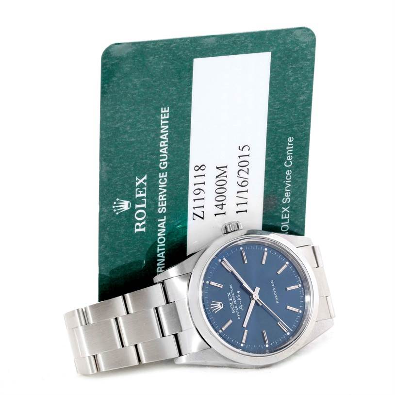 The image shows a Rolex Air-King 14000 Men's Stainless Steel Blue Dial 14000 Men's Stainless Steel Blue Dial watch displayed at a slight angle with its service guarantee card in the background.