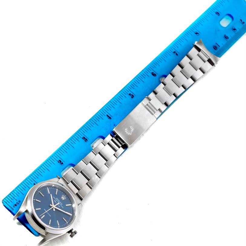 The image shows a top-down view of a Rolex Air-King 14000 Men's Stainless Steel Blue Dial 14000 Men's Stainless Steel Blue Dial watch, including its face, bracelet, and clasp, with a ruler for scale.