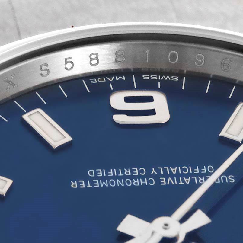 The image shows a close-up of the Rolex Air-King 114200 Men's Stainless Steel Blue Dial 114200 Men's Stainless Steel Blue Dial dial, highlighting the '9' numeral, markers, and part of the hands.