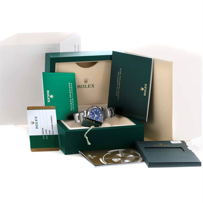 This image shows a Rolex Air-King 114200 Men's Stainless Steel Blue Dial 114200 Men's Stainless Steel Blue Dial watch with its box, warranty card, manuals, and packaging from a front angle.