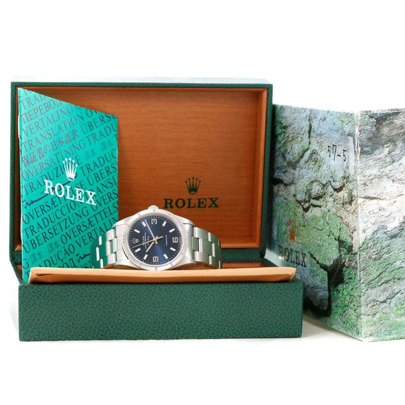The Rolex Air-King 14010 Stainless Steel Blue Dial 14010 Stainless Steel Blue Dial watch is displayed front-facing in its opened box with booklets partially visible.