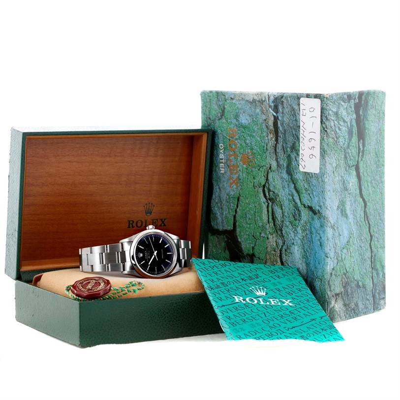 This image shows a Rolex Air-King 14000 Men's Stainless Steel Black Dial 14000 Men's Stainless Steel Black Dial watch resting in its open, branded box with additional documentation beside it.