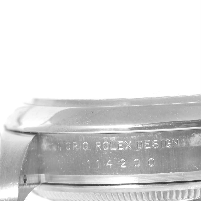 This image shows a close-up of the side of the case of a Rolex Air-King 114200 Men's Stainless Steel Pink Dial 114200 Men's Stainless Steel Pink Dial model, displaying the engraved text.