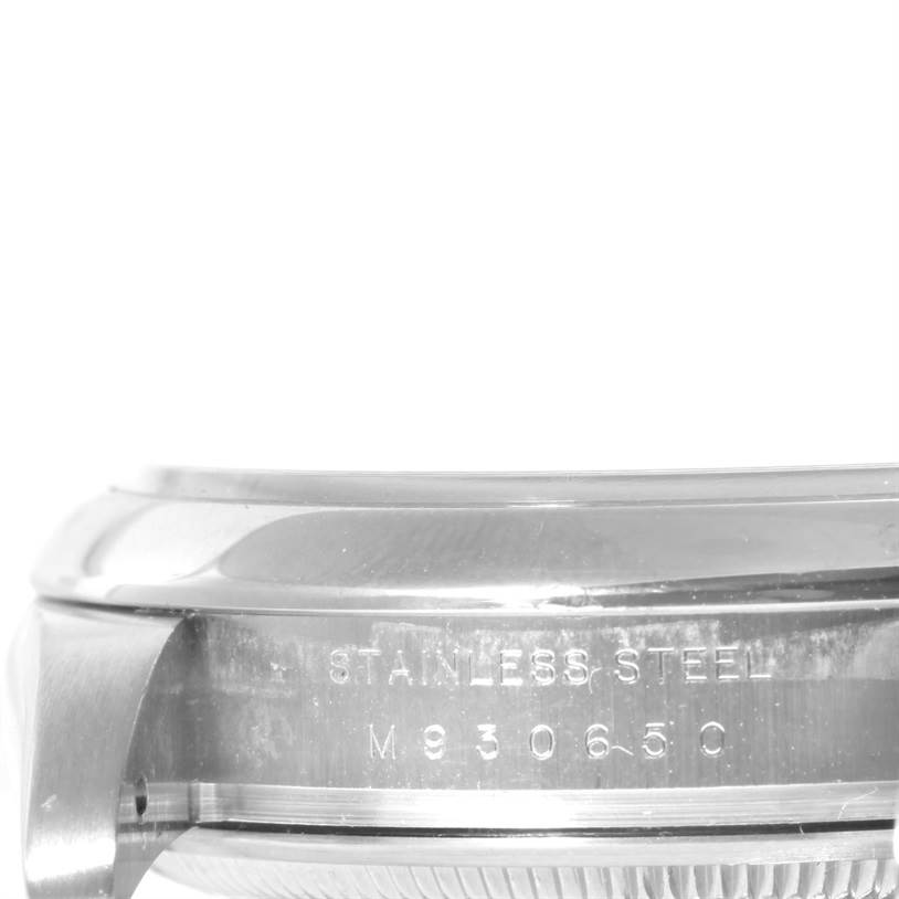 The image shows a side angle of the stainless steel case of a Rolex Air-King 114200 Men's Stainless Steel Pink Dial 114200 Men's Stainless Steel Pink Dial watch, displaying part of its model number engraving.