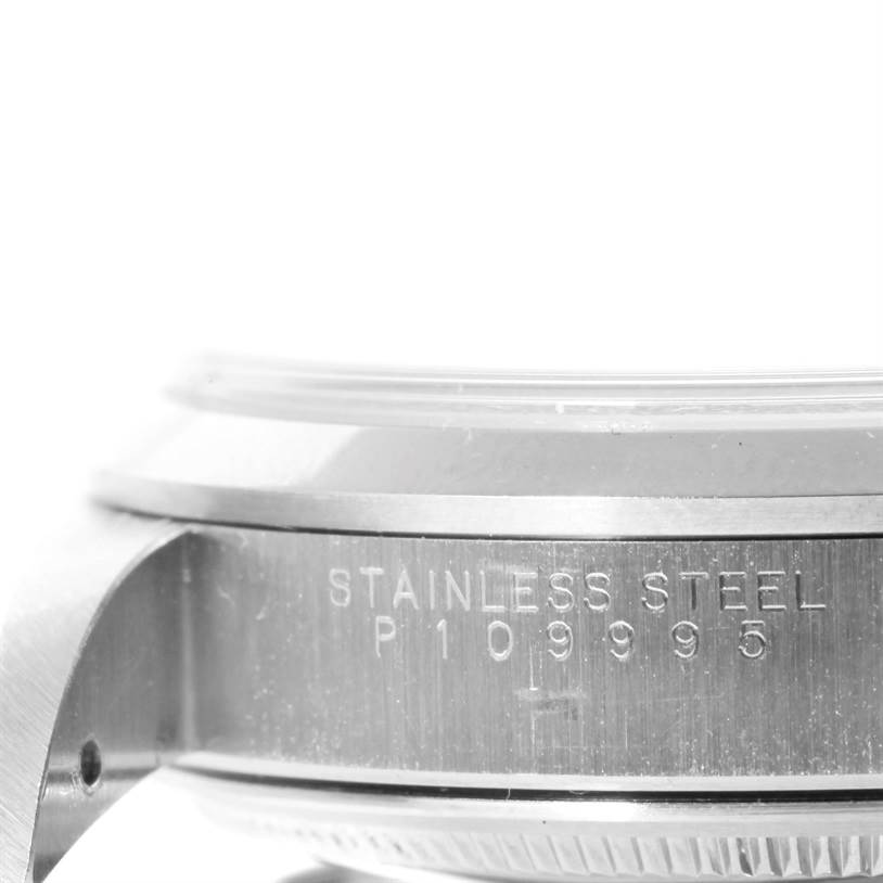 The image shows a close-up, side view of the case of a Rolex Air-King 14000 Men's Stainless Steel Pink Dial 14000 Men's Stainless Steel Pink Dial watch, highlighting the serial number and "Stainless Steel" engraving.