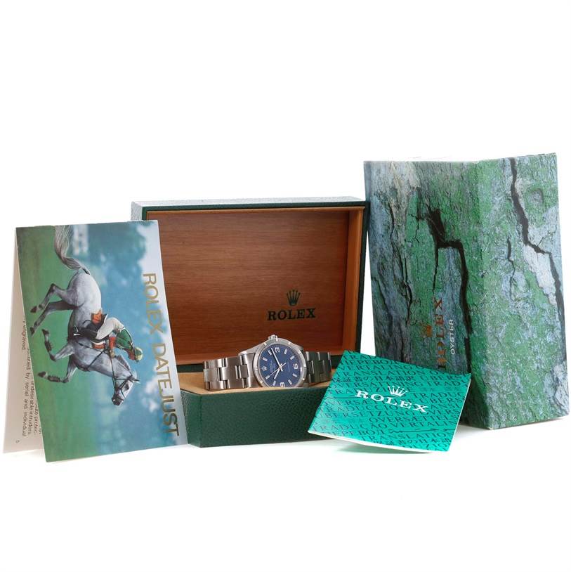 The image shows a Rolex Air-King 14010 Men's Stainless Steel Blue Dial 14010 Men's Stainless Steel Blue Dial watch in an open box, along with its packaging and booklets.