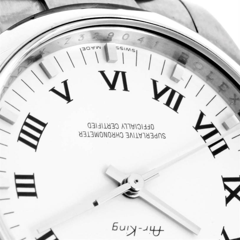 This close-up image of the Rolex Air-King 114200 Men's Stainless Steel White Dial 114200 Men's Stainless Steel White Dial watch shows its dial, hands, and partial case from a tilted angle.