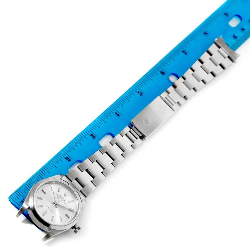 This image shows a Rolex Air-King 14000 Men's Stainless Steel Silver Dial 14000 Men's Stainless Steel Silver Dial watch laid out flat next to a blue ruler, displaying the face and entire metal bracelet.