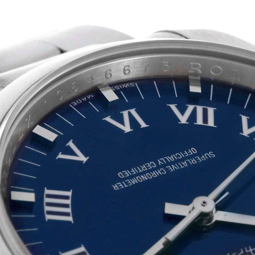 The image shows a close-up, angled view of the dial and part of the bezel of a Rolex Air-King 114200 Men's Stainless Steel Blue Dial 114200 Men's Stainless Steel Blue Dial watch.