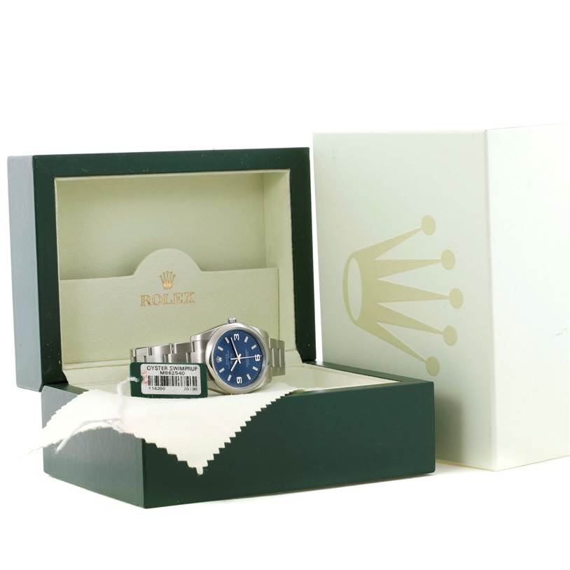 The Rolex Air-King 114200 Men's Stainless Steel Blue Dial 114200 Men's Stainless Steel Blue Dial watch is shown from the front, placed in its open box, with a visible dial and part of the bracelet.
