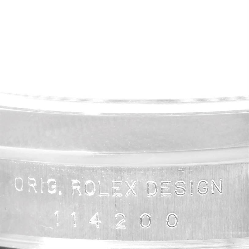 This image shows an engraved detail on the case side of a Rolex Air-King 114200 Men's Stainless Steel Blue Dial 114200 Men's Stainless Steel Blue Dial watch with the model number 114200.