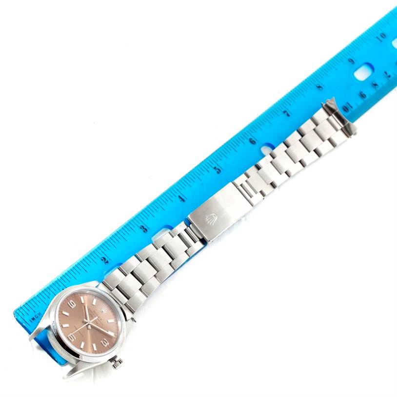 The image shows a Rolex Air-King 14000 Men's Stainless Steel Pink Dial 14000 Men's Stainless Steel Pink Dial watch laid flat with its stainless steel strap and clasp positioned against a ruler for size reference.