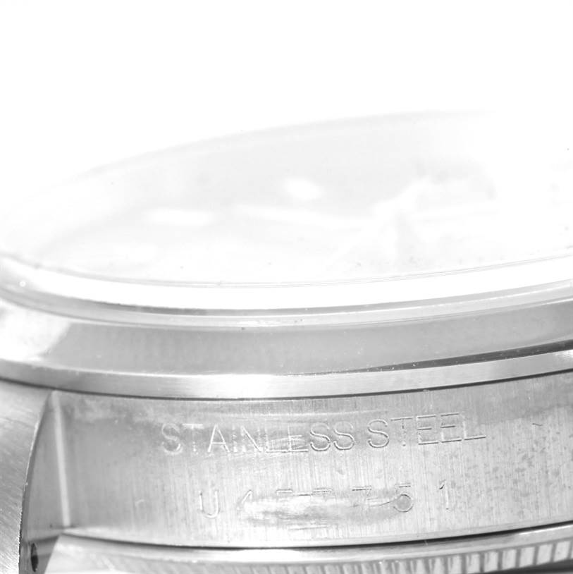 This image shows a close-up of the side and bezel of a Rolex Air-King 14000 Men's Stainless Steel Pink Dial 14000 Men's Stainless Steel Pink Dial watch, highlighting the "Stainless Steel" engraving.