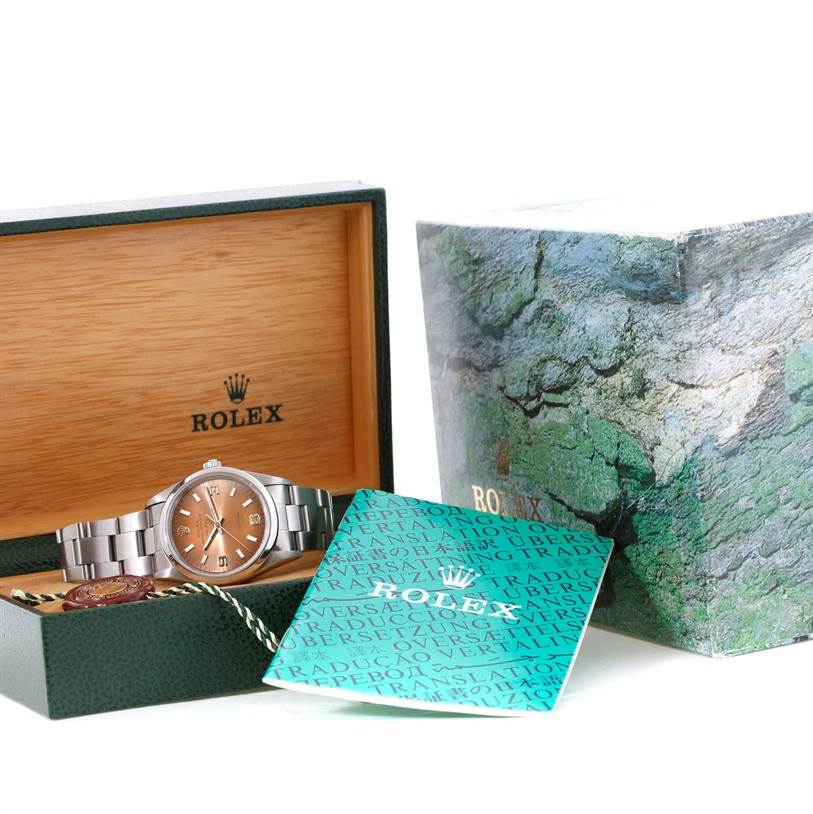 The Rolex Air-King 14000 Men's Stainless Steel Pink Dial 14000 Men's Stainless Steel Pink Dial watch is shown in its open wooden box with accompanying booklet and outer packaging visible.
