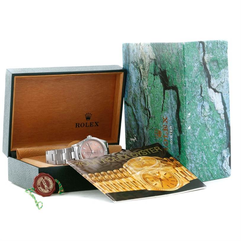 The image shows a Rolex Air-King 14010 Stainless Steel Pink Dial 14010 Stainless Steel Pink Dial watch displayed at an angle inside its opened box, alongside its packaging and a booklet.