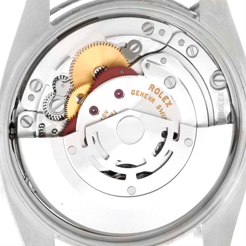 The image shows a close-up of the movement components of a Rolex Air-King 114200 Men's Stainless Steel Blue Dial 114200 Men's Stainless Steel Blue Dial watch, including gears and the rotor marked "Rolex Geneve Swiss."