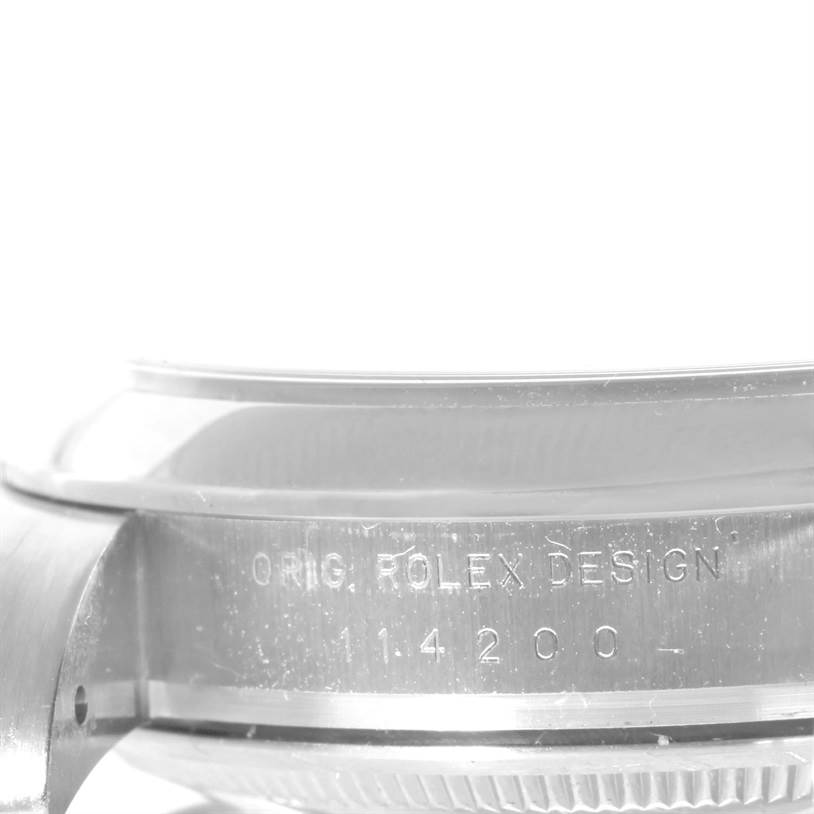 This image shows a close-up view of the side of a Rolex Air-King 114200 Men's Stainless Steel Blue Dial 114200 Men's Stainless Steel Blue Dial watch case, featuring its engraved model number.