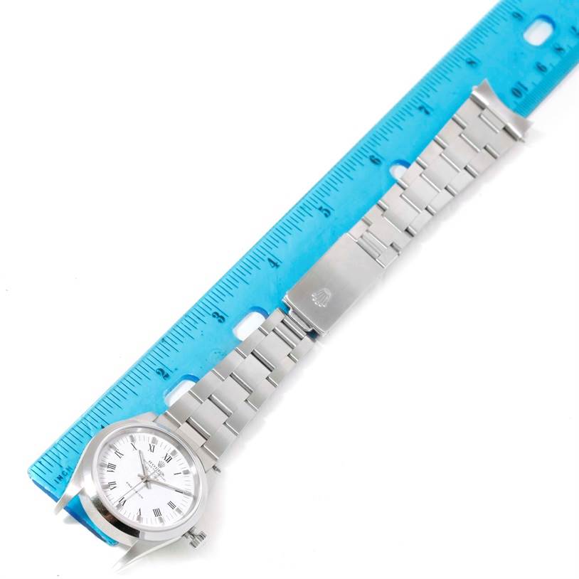 The image shows the Rolex Air-King 14000 Men's Stainless Steel White Dial 14000 Men's Stainless Steel White Dial watch lying flat with a blue ruler alongside it, highlighting its bracelet and clasp.