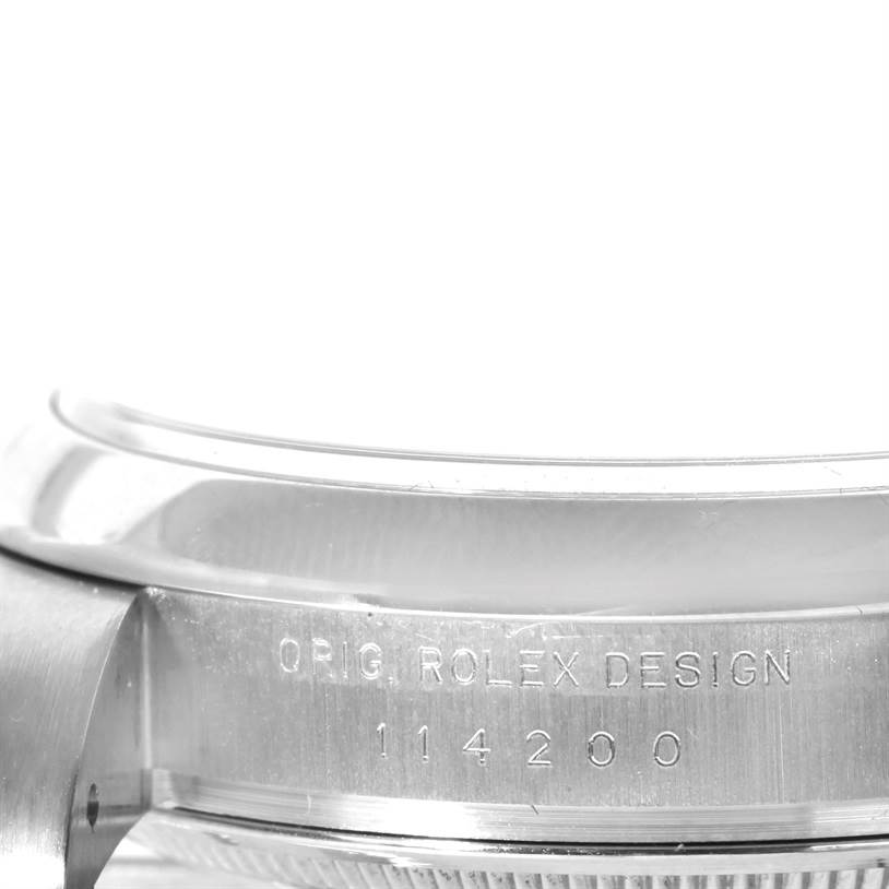 The image shows a close-up of the side of the case of a Rolex Air-King 114200 Men's Stainless Steel Silver Dial 114200 Men's Stainless Steel Silver Dial watch, highlighting the engraved model number 114200.