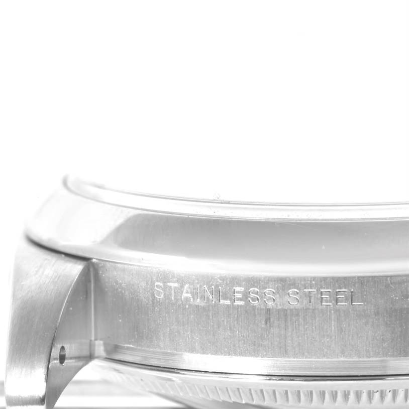 This image shows a close-up side view of the stainless steel case of a Rolex Air-King 114200 Men's Stainless Steel Silver Dial 114200 Men's Stainless Steel Silver Dial watch.