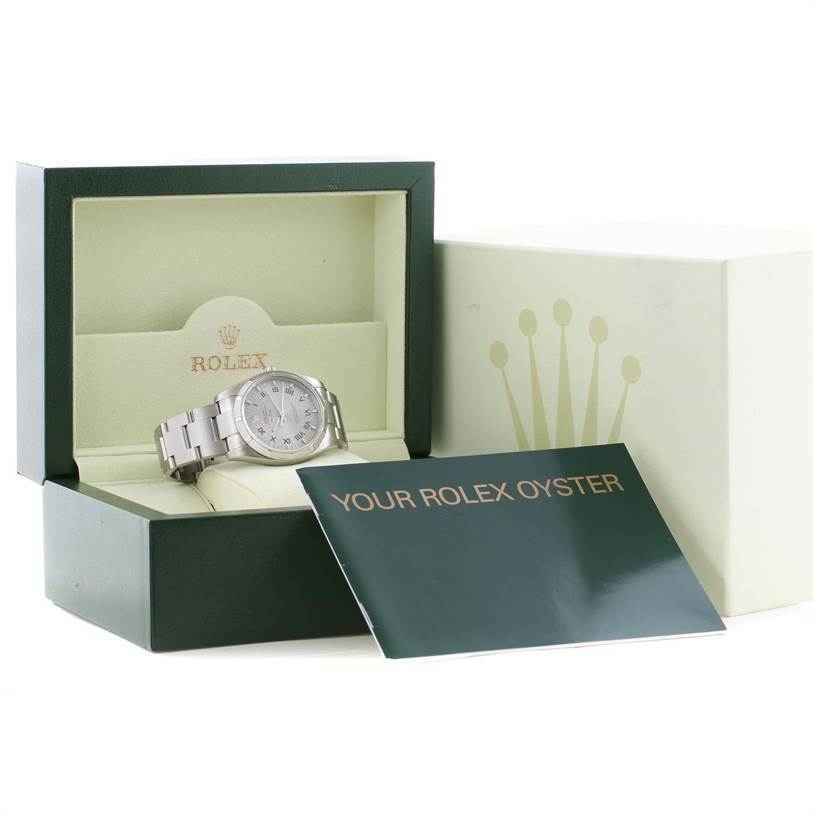 The Rolex Air-King 114210 Men's Stainless Steel Silver Dial 114210 Men's Stainless Steel Silver Dial watch is displayed in an open box with the lid open, accompanied by a green booklet labeled "Your Rolex Oyster".