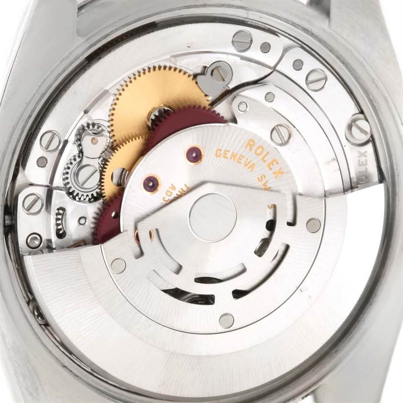 The image shows an internal view of the Rolex Air-King 114210 Men's Stainless Steel Silver Dial 114210 Men's Stainless Steel Silver Dial movement, highlighting gears and mechanical components.