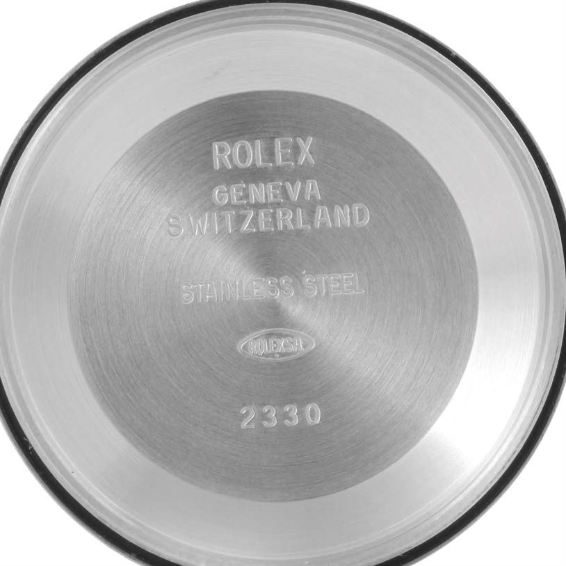 This image shows the inside of the case back of a Rolex Air-King 114200 Men's Stainless Steel Silver Dial 114200 Men's Stainless Steel Silver Dial watch, displaying engraved text and codes.