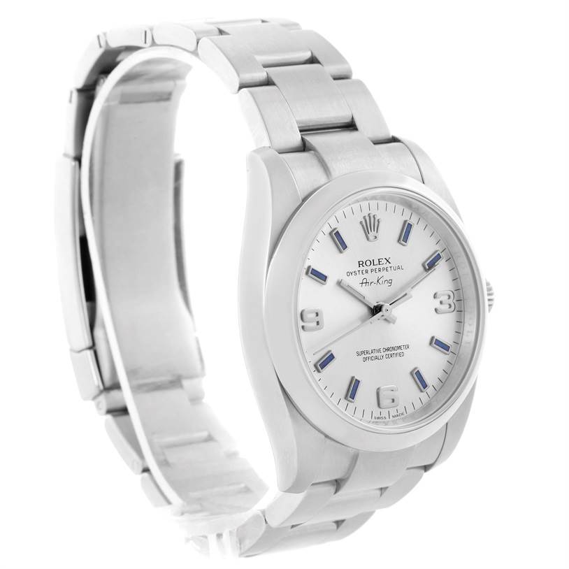 The Rolex Air-King 114200 Men's Stainless Steel Silver Dial 114200 Men's Stainless Steel Silver Dial watch is shown from an angled side view, featuring its white dial, bezel, and stainless steel bracelet.