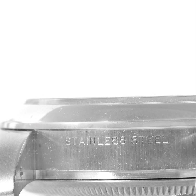 This image shows a close-up side view of the stainless steel case of a Rolex Air-King 114200 Men's Stainless Steel Silver Dial 114200 Men's Stainless Steel Silver Dial watch.
