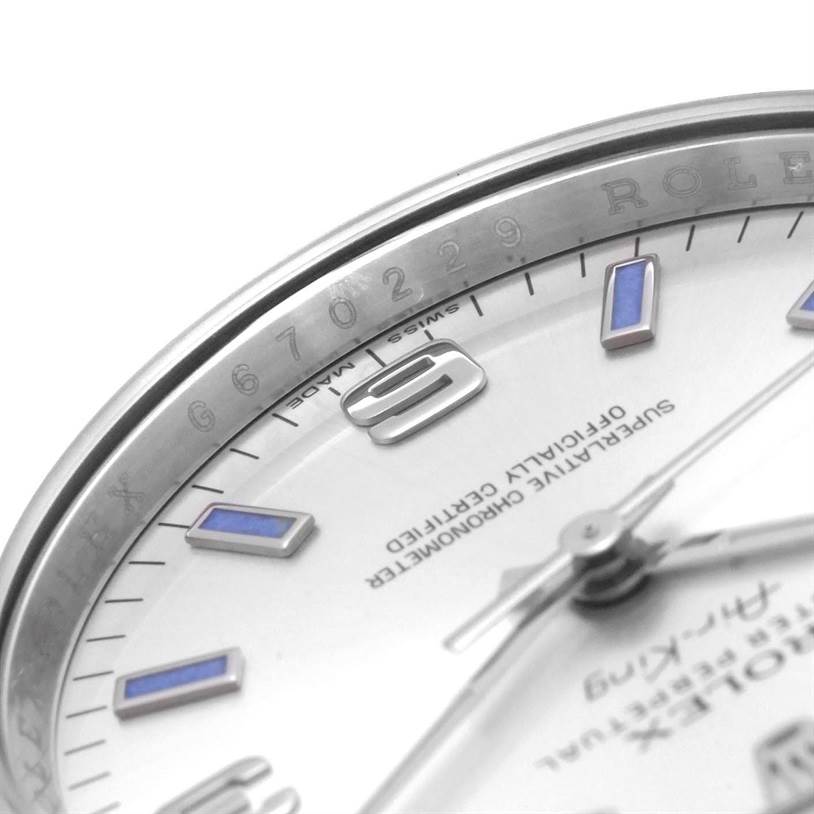 The image shows a close-up view of the Rolex Air-King 114200 Men's Stainless Steel Silver Dial 114200 Men's Stainless Steel Silver Dial watch, focusing on the bezel, partial dial, and part of the hour markers.