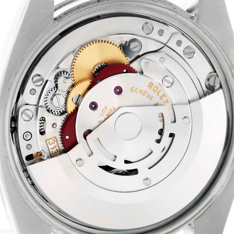 The image shows the inner mechanical movement of a Rolex Air-King 114200 Men's Stainless Steel Silver Dial 114200 Men's Stainless Steel Silver Dial watch, highlighting gears and the oscillating weight.