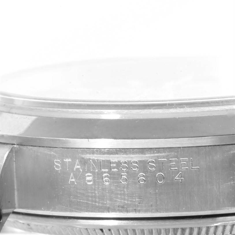 This image shows a close-up of the side of a Rolex Air-King 14000 Men's Stainless Steel Pink Dial 14000 Men's Stainless Steel Pink Dial watch, highlighting the stainless steel material and serial number.