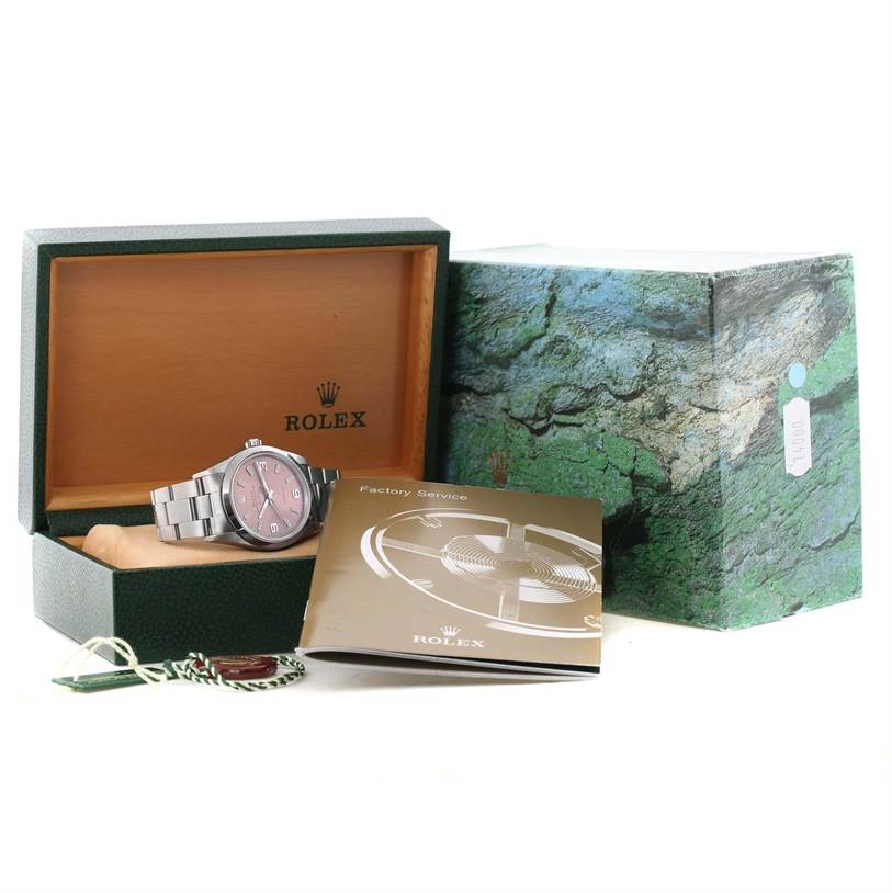 The Rolex Air-King 14000 Men's Stainless Steel Pink Dial 14000 Men's Stainless Steel Pink Dial watch is shown at a slight angle in its open box, along with booklets and tags.