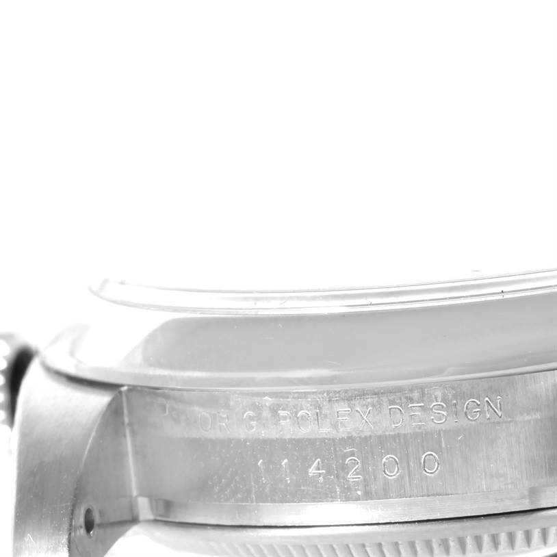 This image shows a close-up side view of the bezel and part of the case of a Rolex Air-King 114200SASO Men's Stainless Steel Silver Dial 114200SASO Men's Stainless Steel Silver Dial watch, with the model number engraved.