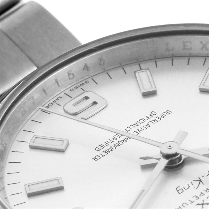 Close-up of the dial and bezel of a Rolex Air-King 114200SASO Men's Stainless Steel Silver Dial 114200SASO Men's Stainless Steel Silver Dial, showing the 9 o'clock marker and brand inscriptions.