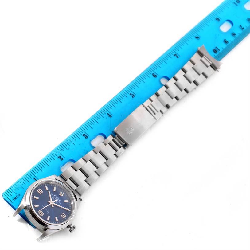 This image shows a Rolex Air-King 14000 Men's Stainless Steel Blue Dial 14000 Men's Stainless Steel Blue Dial watch laid flat next to a ruler, showcasing the watch face, band, and clasp.