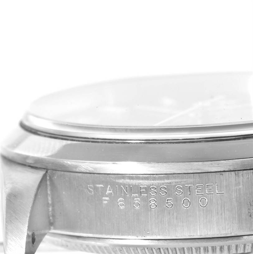 This image shows a close-up side view of the case and bezel of a Rolex Air-King 14000 Men's Stainless Steel Blue Dial 14000 Men's Stainless Steel Blue Dial watch, emphasizing the "Stainless Steel" engraving and serial number.