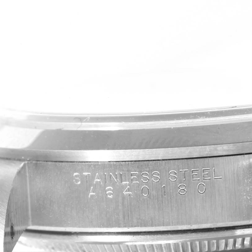 The image shows a close-up of the side of a Rolex Air-King 14000 Men's Stainless Steel White Dial 14000 Men's Stainless Steel White Dial watch case, highlighting the serial number and "STAINLESS STEEL" engraving.