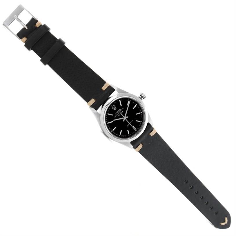 The Rolex Air-King 14000 Men's Stainless Steel Black Dial 14000 Men's Stainless Steel Black Dial watch is shown from a top-down angle, displaying its black dial, silver case, and black leather strap.