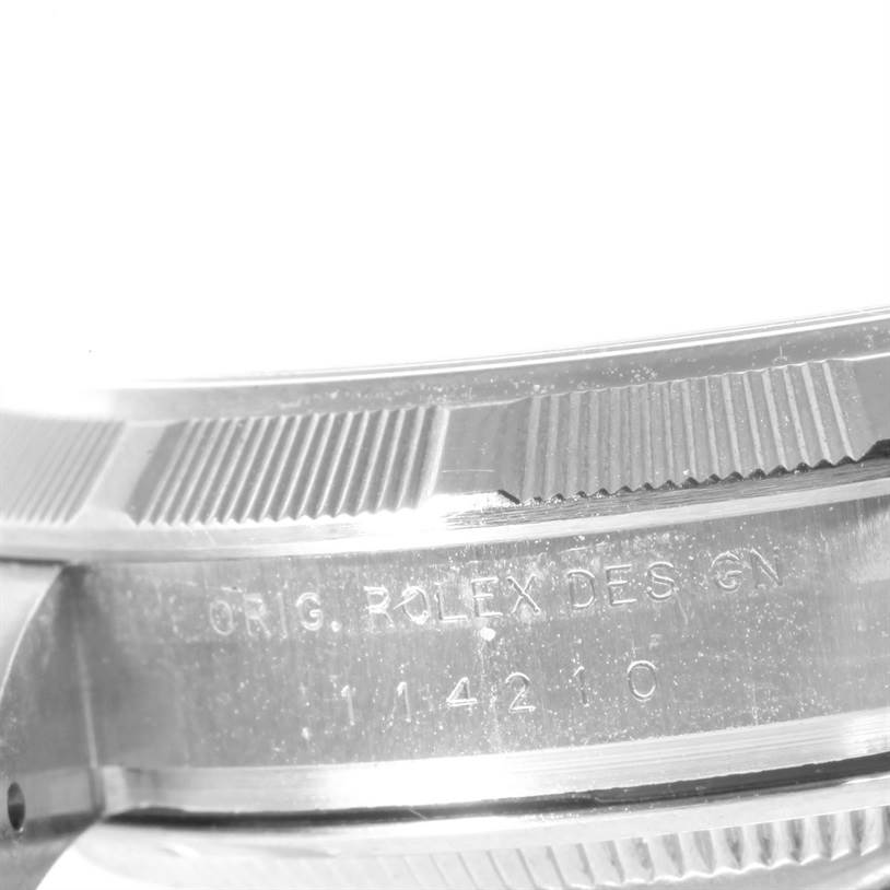 This image shows a close-up of the side engraving on the case of a Rolex Air-King 114210 Men's Stainless Steel Silver Dial 114210 Men's Stainless Steel Silver Dial watch, featuring the "ORIG. ROLEX DES. GIN" inscription.
