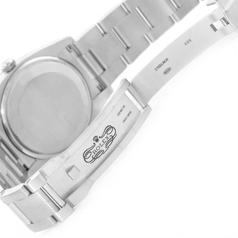 This image shows the back case and open clasp of a Rolex Air-King 114210 Men's Stainless Steel Silver Dial 114210 Men's Stainless Steel Silver Dial watch, highlighting the engraved logo and bracelet links.