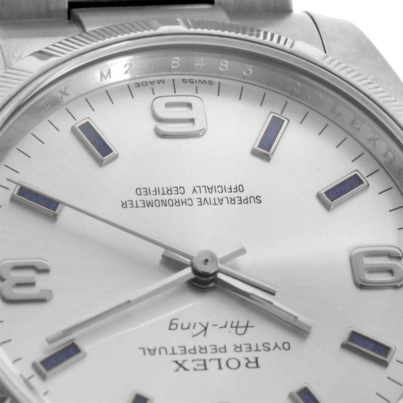 This close-up of the Rolex Air-King 114210 Men's Stainless Steel Silver Dial 114210 Men's Stainless Steel Silver Dial watch shows the dial, hands, hour markers, and part of the bezel.
