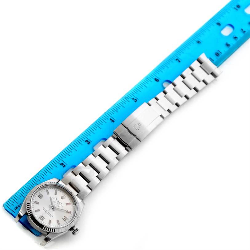 The image shows a top-down view of a Rolex Air-King 114234SAPSO Men's Stainless Steel Silver Dial 114234SAPSO Men's Stainless Steel Silver Dial watch, focusing on the dial, bracelet, and clasp, with a ruler for scale.