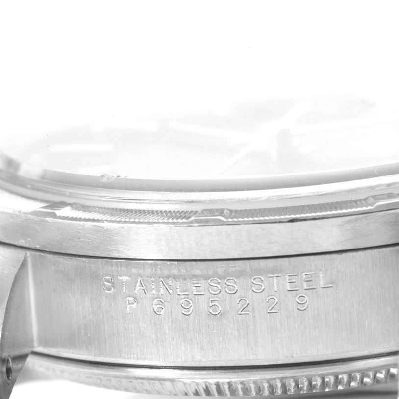 The image shows a close-up, side view of the stainless steel case of a Rolex Air-King 14010 Men's Stainless Steel Black Dial 14010 Men's Stainless Steel Black Dial watch, highlighting the serial number.