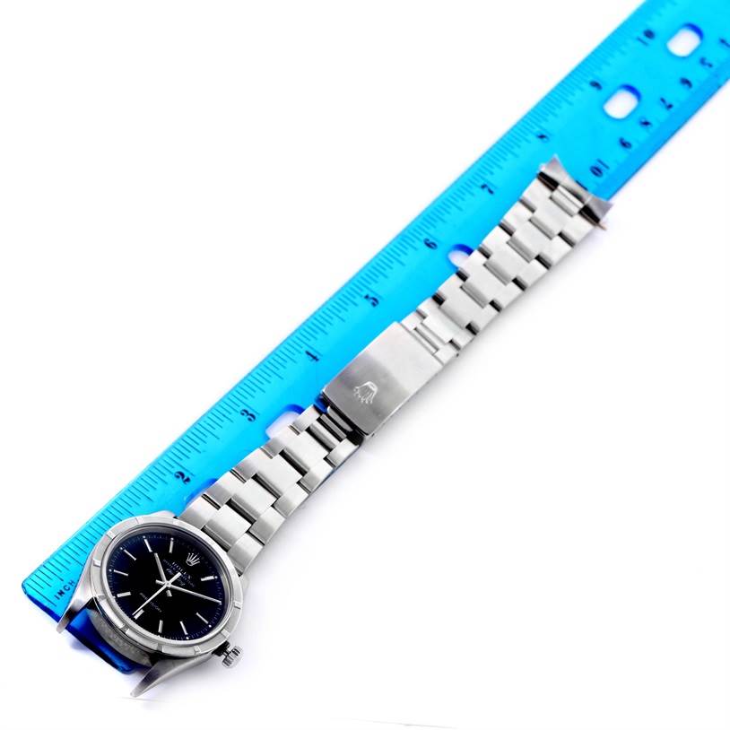 The image shows a Rolex Air-King 14010 Men's Stainless Steel Black Dial 14010 Men's Stainless Steel Black Dial watch laid flat next to a ruler, highlighting the watch face and metal bracelet.