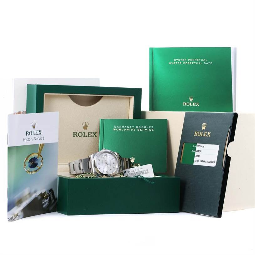 The image shows a Rolex Air-King 114200 Men's Stainless Steel Silver Dial 114200 Men's Stainless Steel Silver Dial watch with its box, warranty booklet, tags, and manuals, from a front angle.
